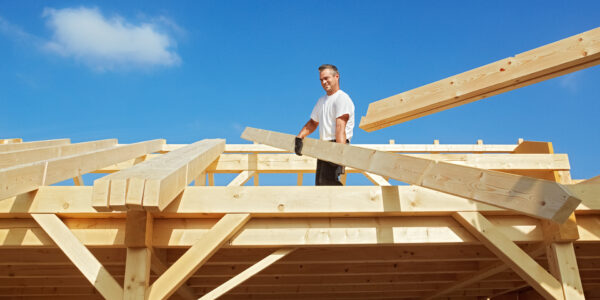 Carpenter,At,Work,,Unloading,Rafters,For,A,Timber,Roof,Truss